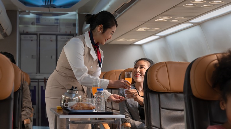 Woman serving passenger a drink