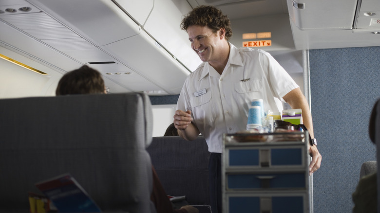 Flight attendant talking to passenger