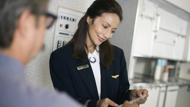 Flight attendant and passenger on plane