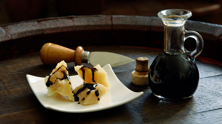 Balsamic vinegar with chunks of cheese.