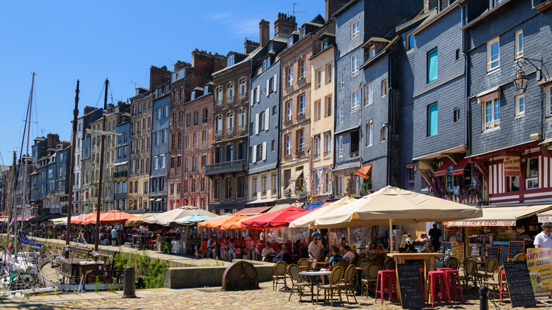 View of restaurants lining the historic facades on the Honfleur harbor