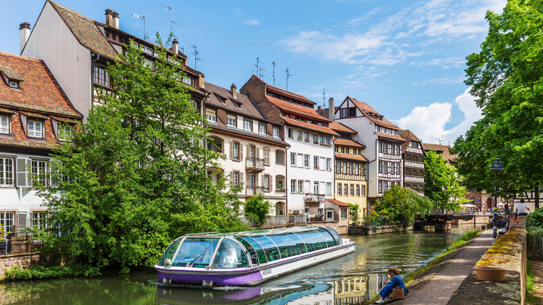 Boat along canal with traditional houses in Strasbourg