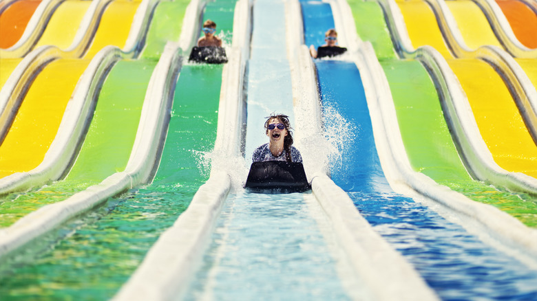 Riders on a water slide