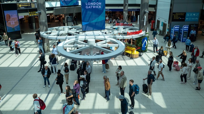 Travelers standing in the south terminal of Gatwick Airport