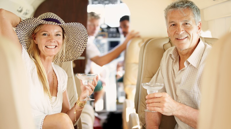 Couple with cocktail on plane