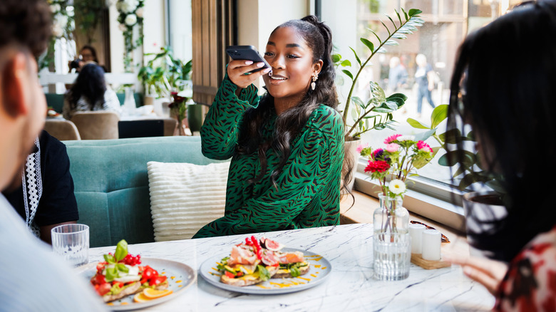 Person taking pictures of trendy food