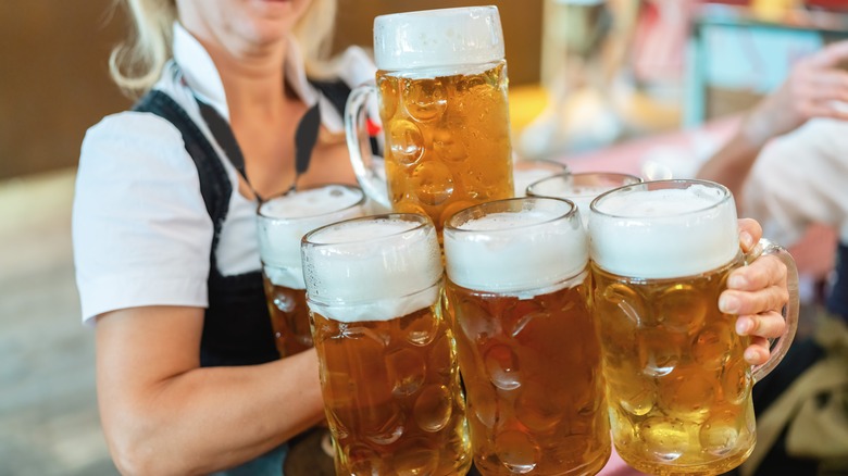 Woman carrying beer steins during Oktoberfest