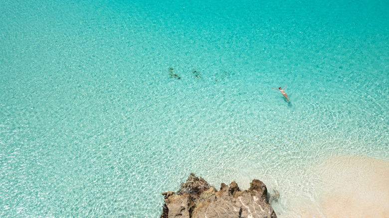 Woman swimming at Mead's beach, Anguilla