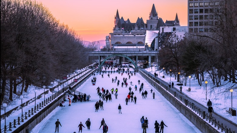 Skaters enjoying the Rideau Canal Skateway at sunset in Ottawa, Canada