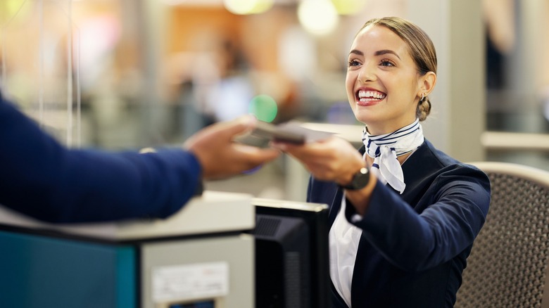 Airport employee smiling at customer