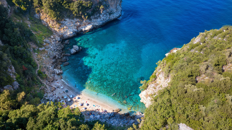 Aerial view of the popular beach at Fakistra, Pelion mountain, Greece, with shining emerald sea