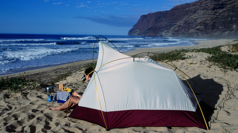 Man camping on a rugged beach