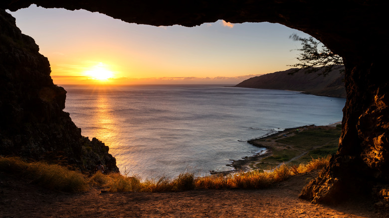 Cave exit overlooking the ocean at sunset