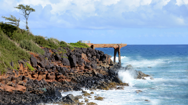 Pineapple Dump Pier and Kauai's rocky coastline next to the ocean