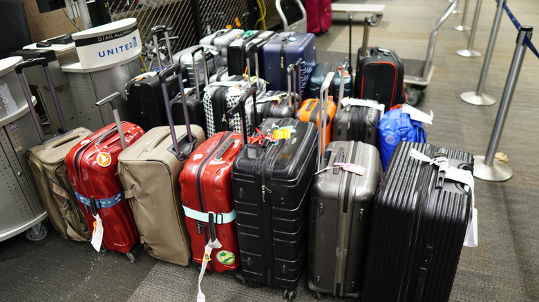 Unclaimed luggage in front of United Airlines desk