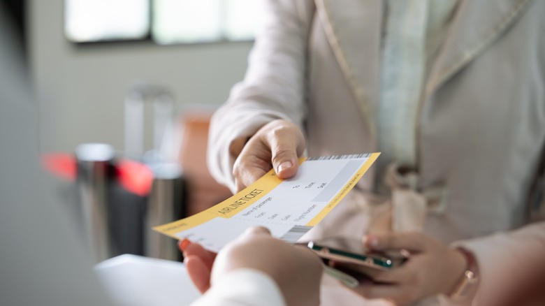 Person getting boarding pass checked