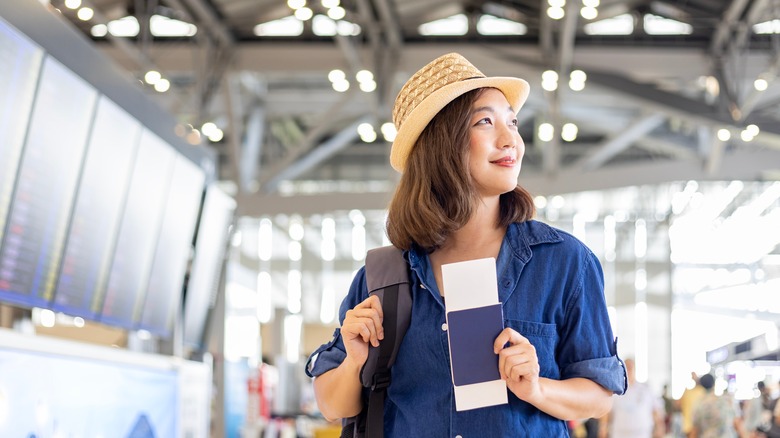 Woman holding boarding pass at airport