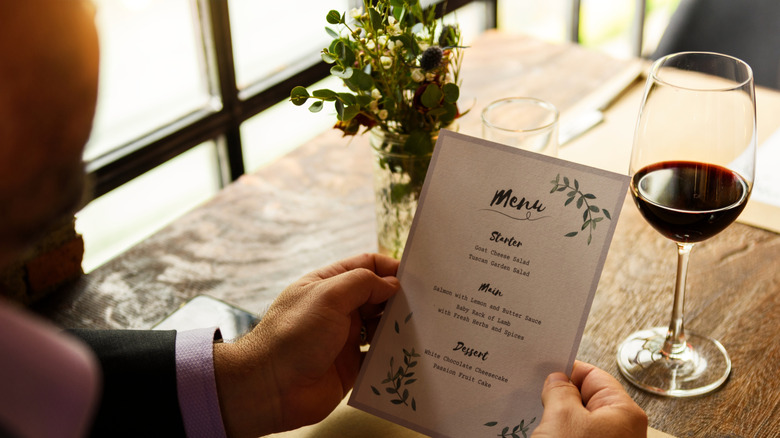 Diner reading a menu