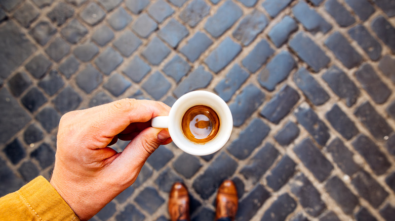 Espresso against a cobblestone background