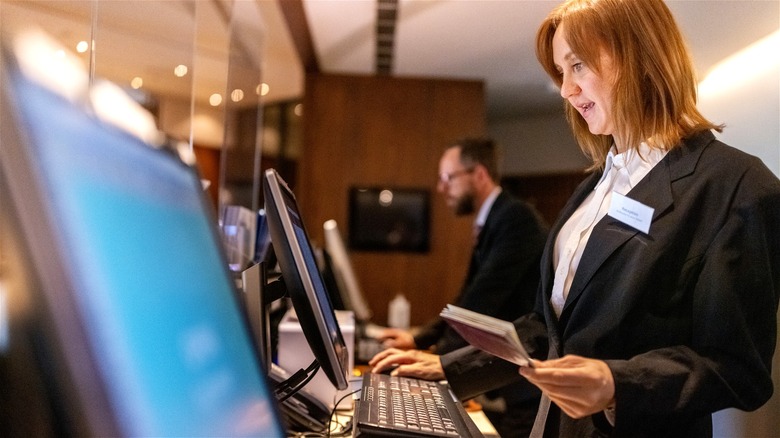 Hotel receptionist checking passport