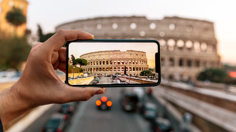 Person taking photo of Colosseum