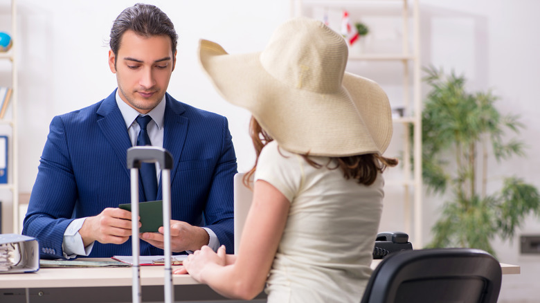 Woman having passport examined