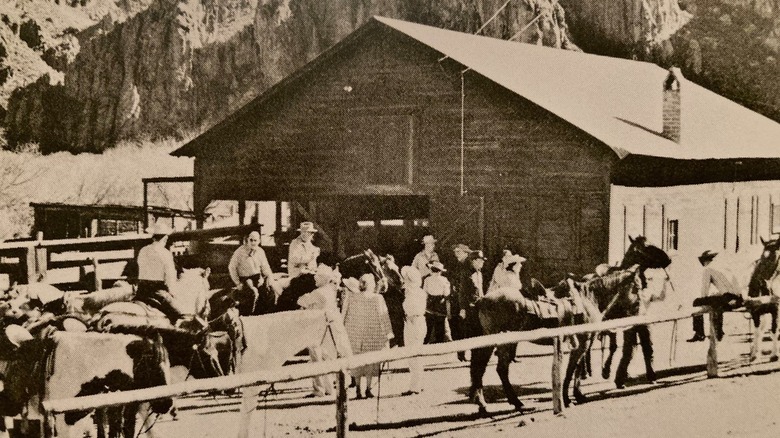 A historic photo of Saguaro Lake Guest Ranch with people on horseback