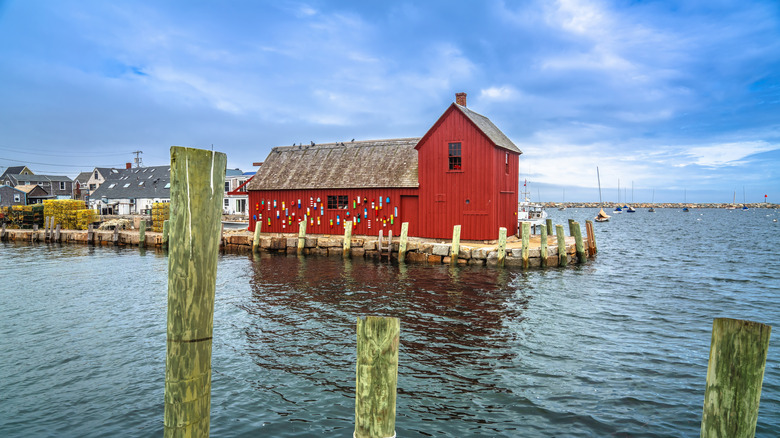 Red fishing shack in Rockport surrounded by water