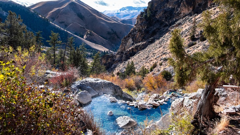 A natural hotspring stone pool overlooking a mountainous valley