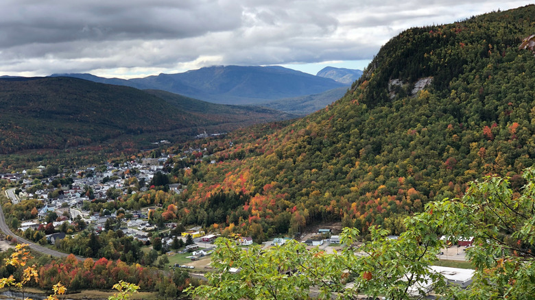 An aerial view of Berlin, New Hampshire, featuring greenery and mountains