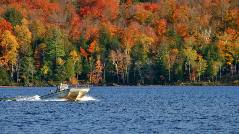 Boat on Schroon Lake with colorful fall foliage