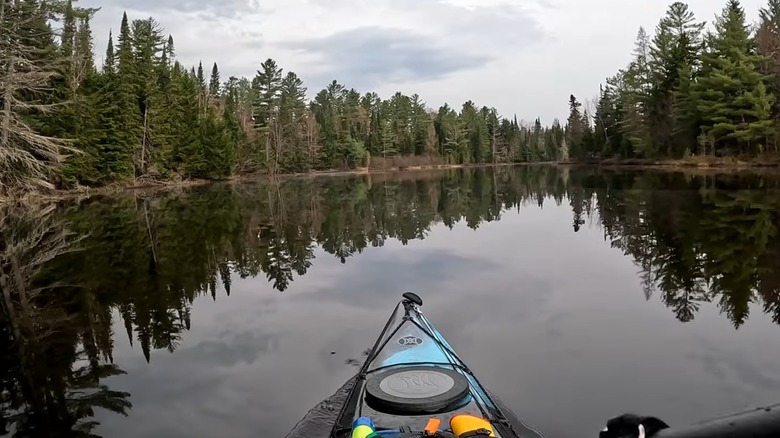 Kayak on Lake Clear surrounded by tall trees