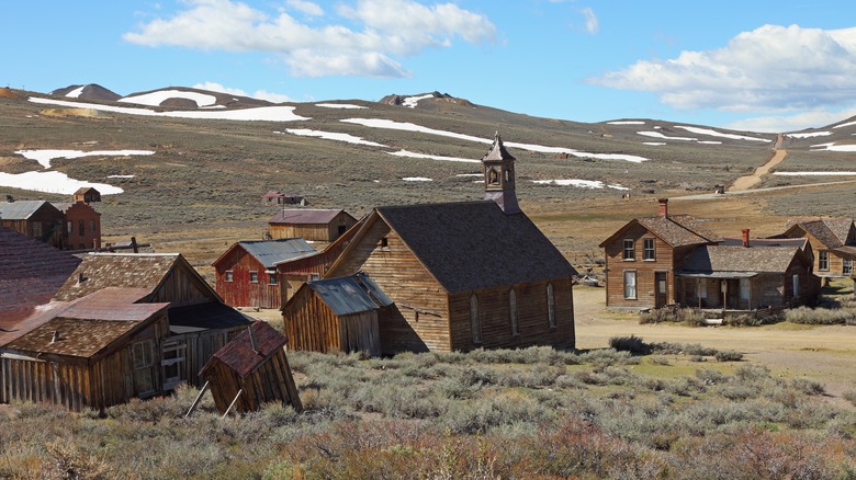 Wooden buildings and snow-covered fields at Bodie ghost town in California