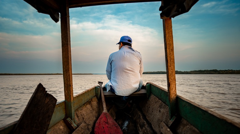 Man on a boat tour along the Ucayali River in Peru