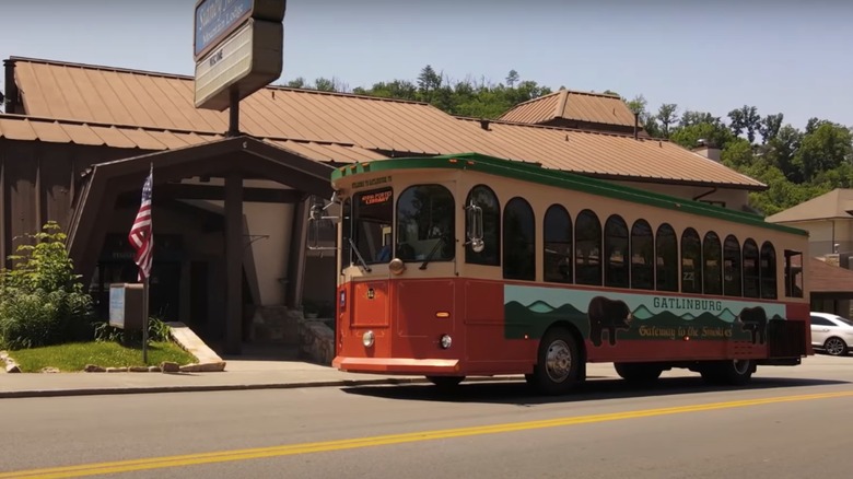 Exterior of the Sidney James Mountain Lodge in Gatlinburg with a trolley in front