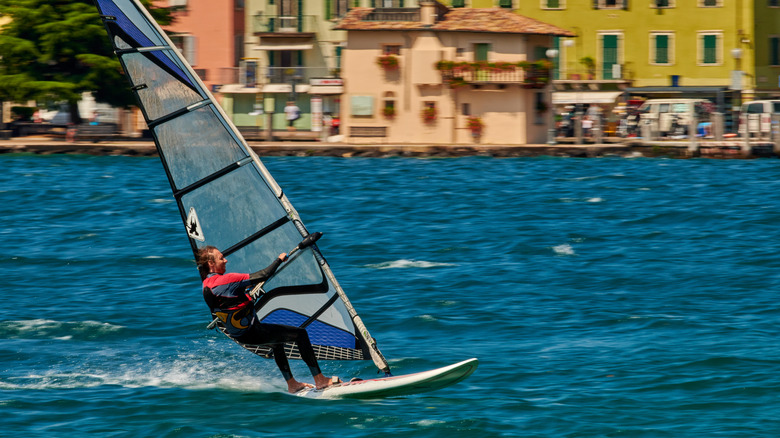 A windsurfer on the lake in Campione del Garda, a town in Tremosine, Italy