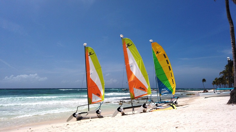 Three colorful windsurfing sails at Hobie Beach