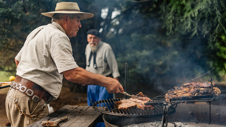 Man grilling meat at a traditional Argentinian parrilla