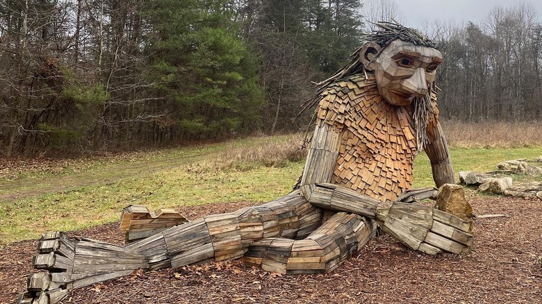 Little Elina sculpture sitting on the ground in Bernheim Forest