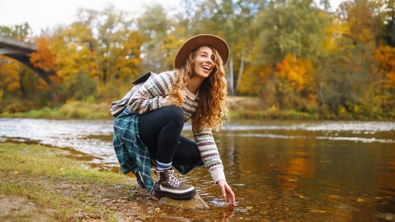 Woman enjoying an autumn river