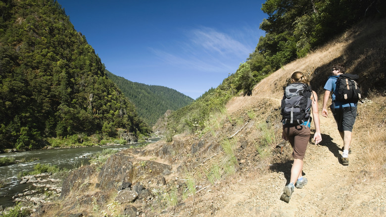 Hikers along a river