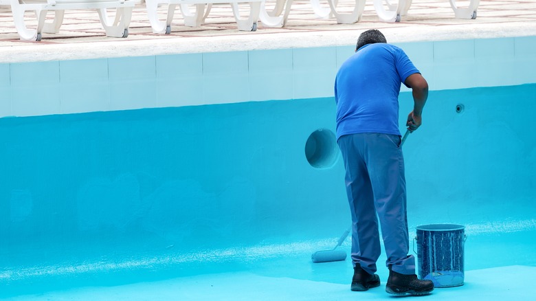 A man painting a pool 