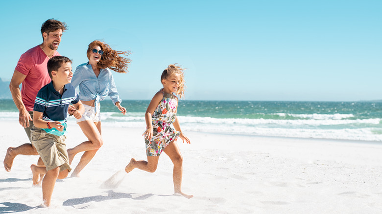 Family running on a beach