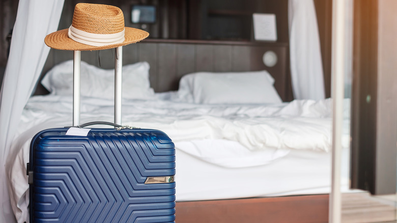 Luggage and a hat in a hotel room