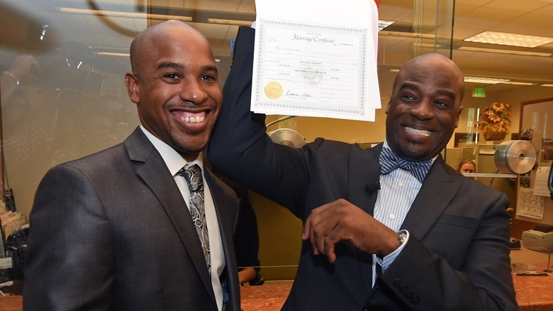 Happy couple shows off their marriage certificate at the Clark County Marriage License Bureau