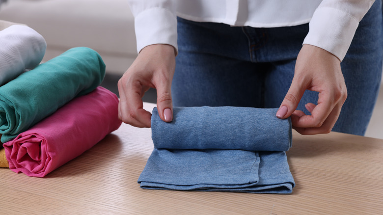 woman rolling t-shirt