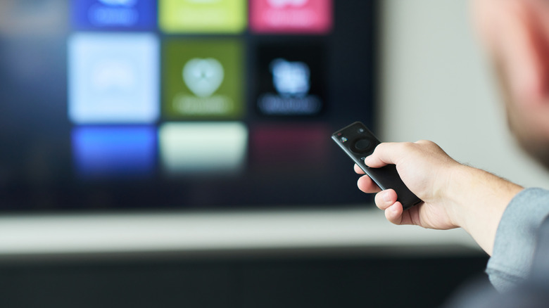 A man looking through apps on a smart TV