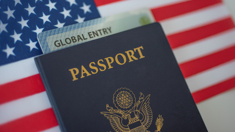 Passport and Global Entry card atop an American flag