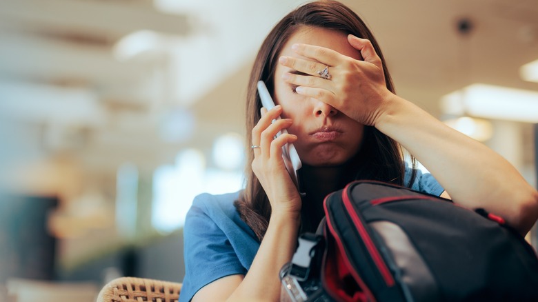 Stressed woman waiting at airport