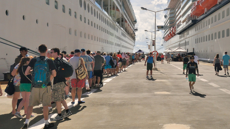 Passengers by a cruise ship